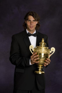 Rafael (Rafa) Nadal in evening dress (a dinner jacket, a tuxedo) with the Men's Wimbledon trophy.