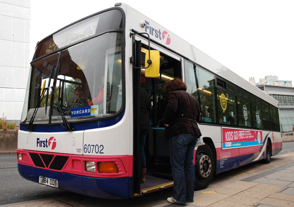 A First York single-decker bus with passengers boarding it.